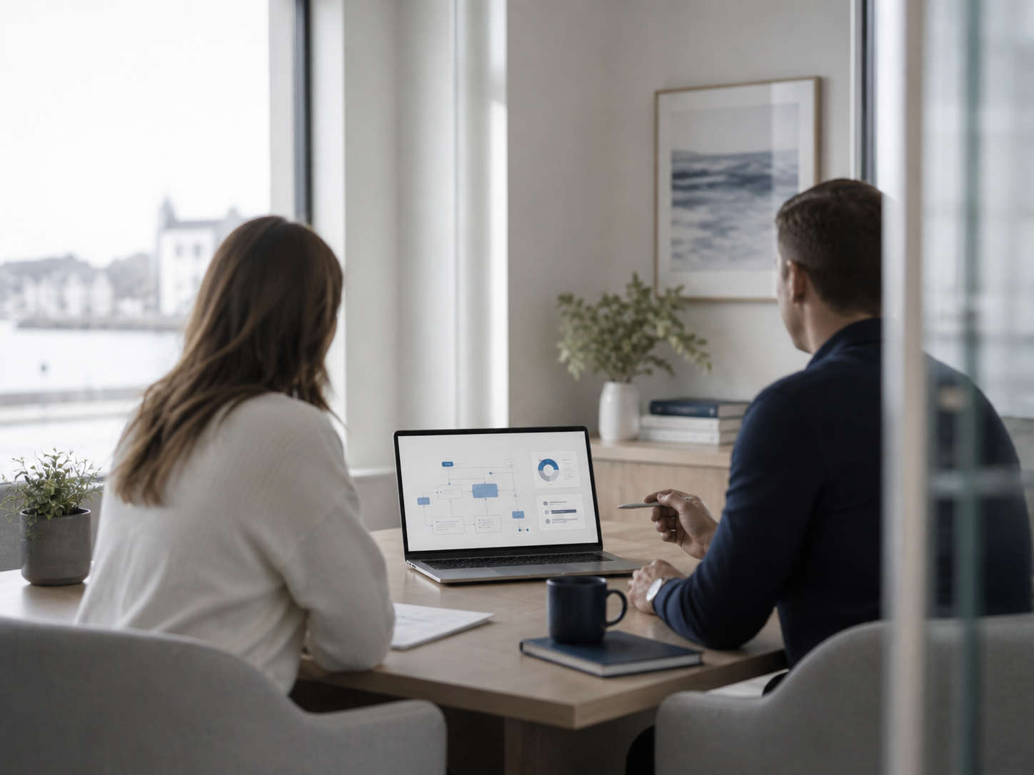 Two people working at a conference table during an AI consultation session